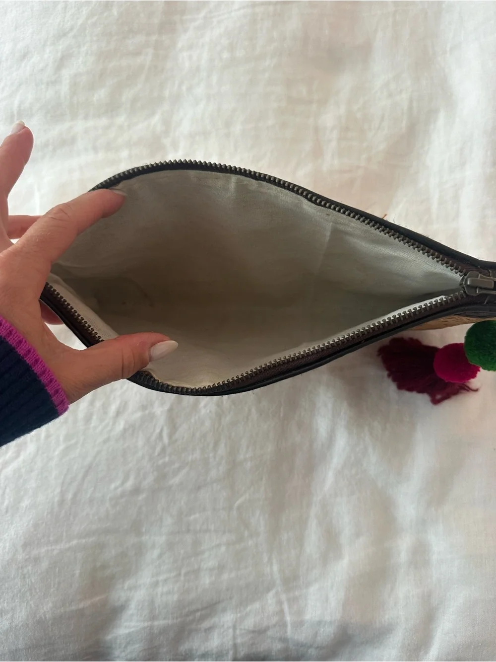 Rattan clutch with pompom zip